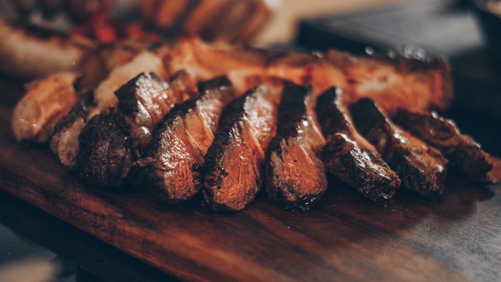 Sliced steak resting on a wooden serving board